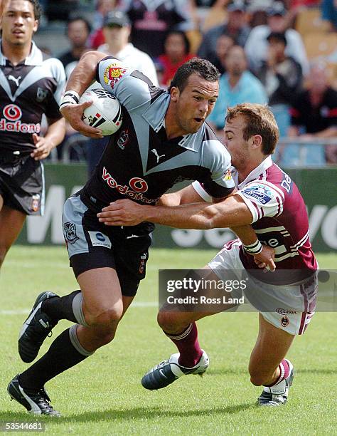 Louis Anderson slips throught the tackle of Brett Stewart to score for thew Warriors during the Manly Sea Eagles 2620 win over the New Zealand...