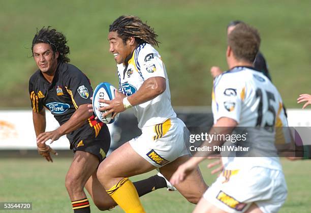 Hurricanes Ma'a Nonu runs past Chiefs Alan Bunting to score his second try in their pre season Super 12 warm up match played at the Growers Stadium...