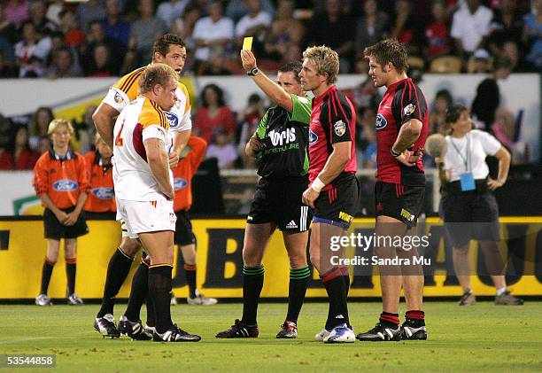 Referee Bryce Lawrence shows the yellow card to both, Scott Linklater and Justin Marshall during round two of the Rugby Super 12 between the...