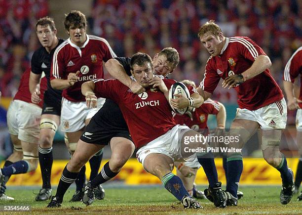 British and Irish Lions Julian White is tackled by All Black Greg Somerville in the third and final rugby union test match played against the All...