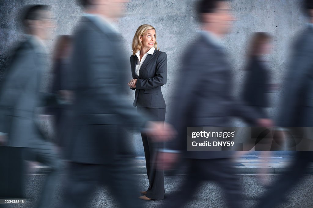 Businesswoman Turns Head To Look In Direction Pedestrians Are Walking
