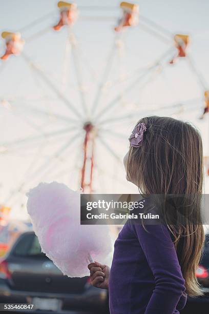 girl eating sugar candy in the amusement park - sockervadd bildbanksfoton och bilder