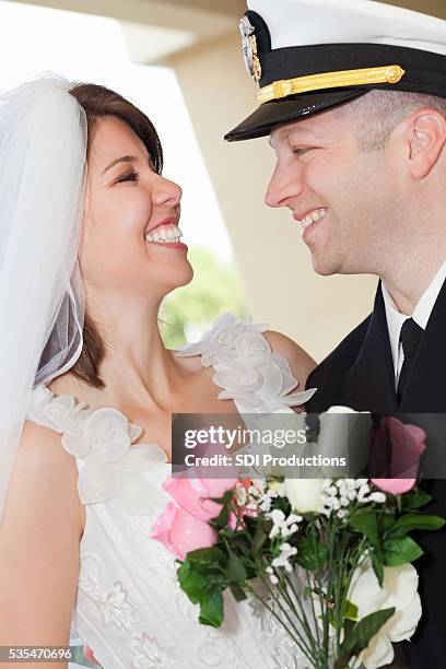 groom in navy uniform and his bride - military chic stock pictures, royalty-free photos & images