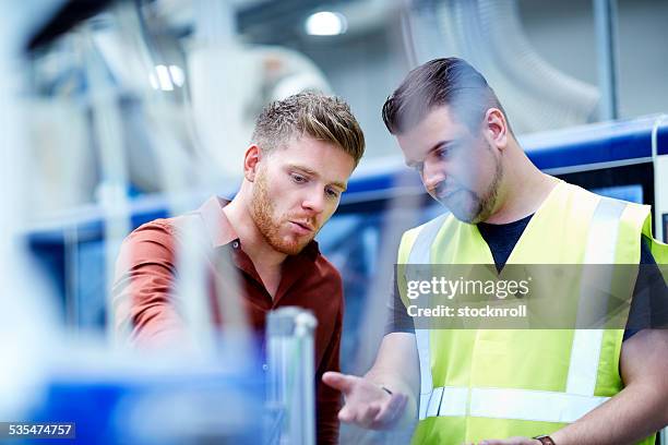 junge männer arbeiten im verarbeitenden anlage - industrial warehouse stock-fotos und bilder