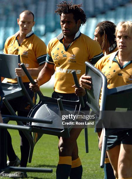 Wallabies Stirling Mortlock , Lote Tuqiri, George Smitt and Phil Waugh carry chairs ferom the frield following their team photograph prior to the...