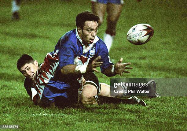 November01. Samoa's Willie Poching is taken to the ground by New Zealand Maori's Paul Whatuira in their Rugby League World Cup match played at...