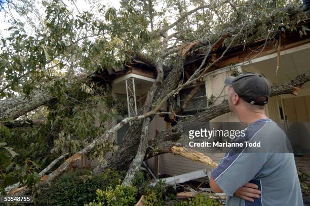 Tommy Townsend stands in front of his damaged home the day after Hurricane Katrina made her way inland August 30, 2005 in Meridian, Mississippi. Gas...
