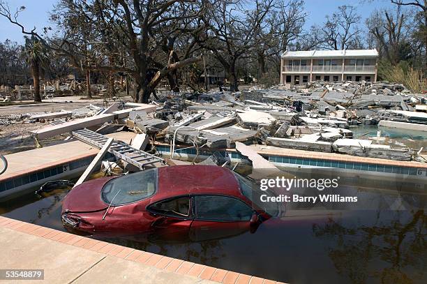 Car is seen in a beachfront pool just across Highway 90 August 30, 2005 in Biloxi, Mississippi. Approximately 100 people are feared dead and...