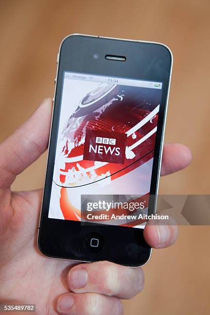 Following BBC news on a i-phone 4, s mart phone connected to the internet.