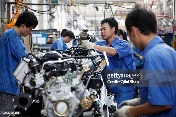 Workers operate on the assembly line at the SAIC GM Wuling Automobile Co., Ltd factory in Liuzhou, Guangxi Province, China, on August 24, 2009. The...