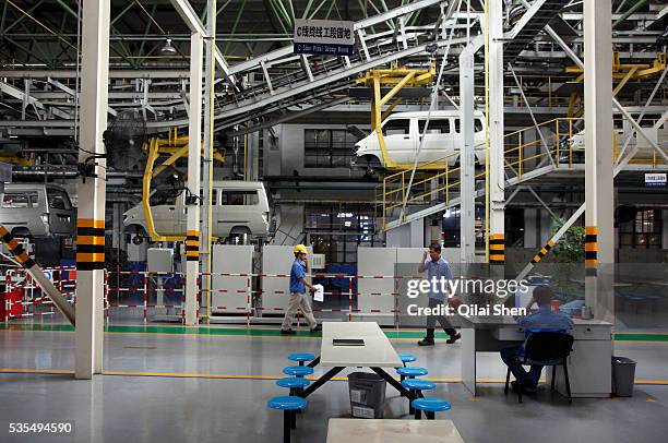 Workers operate on the assembly line at the SAIC GM Wuling Automobile Co., Ltd factory in Liuzhou, Guangxi Province, China, on August 24, 2009. The...