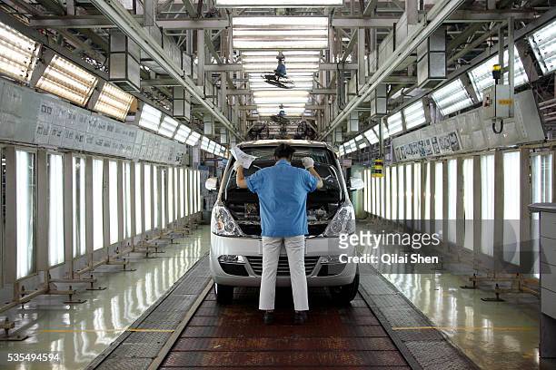 Workers operate on the assembly line at the SAIC GM Wuling Automobile Co., Ltd factory in Liuzhou, Guangxi Province, China, on August 24, 2009. The...