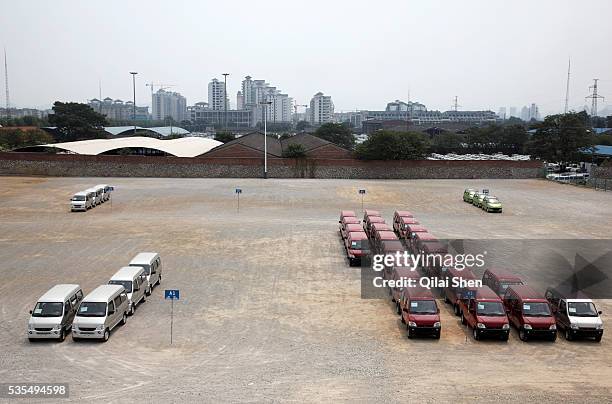 Man walks through a parking lot, almost empty from the high demand, at the SAIC GM Wuling Automobile Co., Ltd factory in Liuzhou, Guangxi Province,...