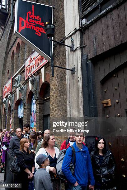 Tourists queue up outside the London Dungeons at London Bridge. The London Dungeon is a popular London tourist attraction,[1] which recreates various...