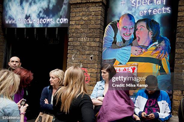 Tourists queue up outside the London Dungeons at London Bridge. The London Dungeon is a popular London tourist attraction,[1] which recreates various...