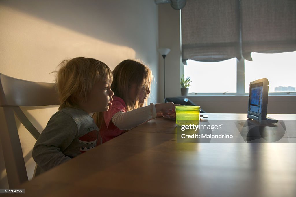 Boy and Girl looking at a digital tablet