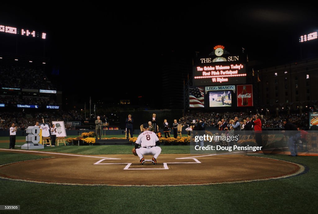 Baltimore Orioloes third baseman Cal Ripken Jr. #8 catches the ceremonial first pitch before his last game