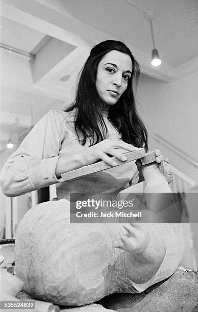 Artist Maria Sol Escobar, known as Marisol, photographed in 1969 working on "Holy Family".