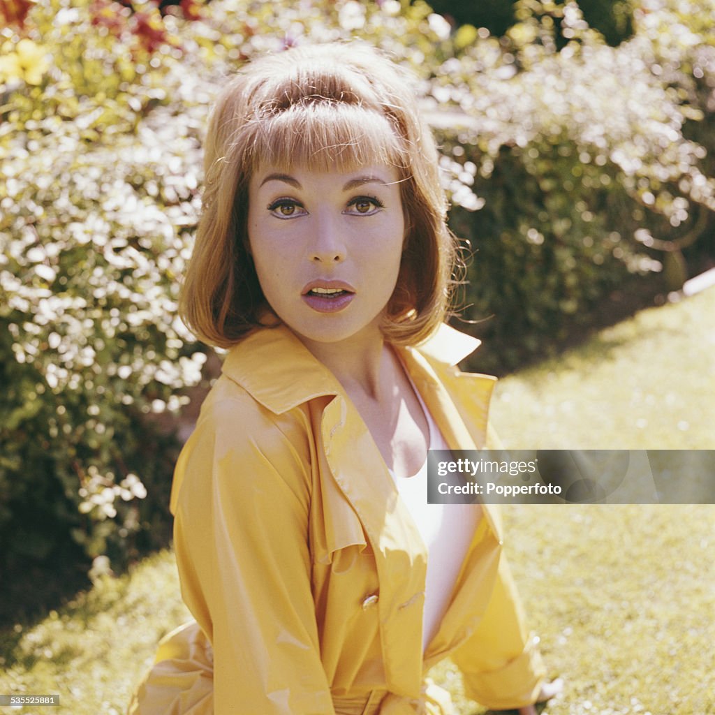 French actress Liliane Brousse pictured wearing a yellow mac during