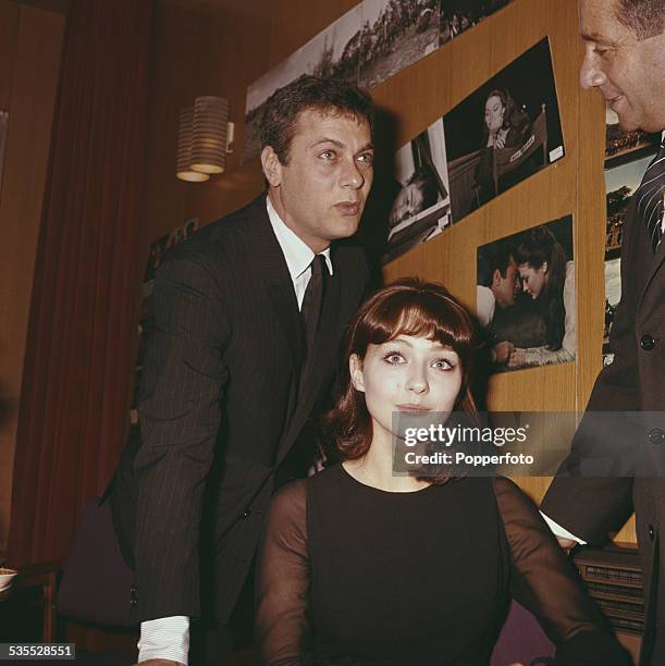 American actor Tony Curtis pictured with German actress and his future wife Christine Kaufmann in London in 1962.