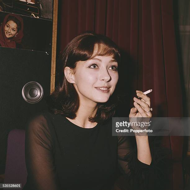 Austrian born German actress Christine Kaufmann pictured smoking a cigarette in London in 1962.