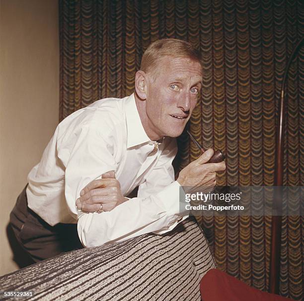 Irish born actor Wilfrid Brambell who plays Albert Steptoe in the television sitcom Steptoe and Son, posed holding a pipe at home in 1962. (Photo by...