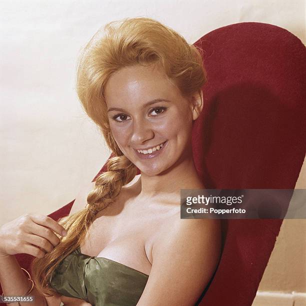 English actress Francesca Annis posed sitting in a red chair in 1962.