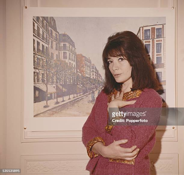 French actress and singer, Juliette Greco pictured wearing a pink jacket in 1962.