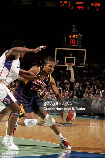 Tamika Catchings of the Indiana Fever drives against Crystal Robinson of the New York Liberty in Game One of the Eastern Conference Semis during the...