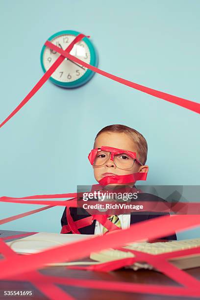 business boy tied up in red tape - administrative professional stock pictures, royalty-free photos & images