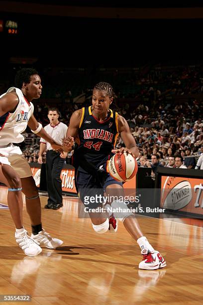 Tamika Catchings of the Indiana Fever drives against Crystal Robinson of the New York Liberty in Game One of the Eastern Conference Semis during the...
