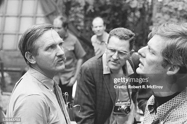 American film director Stan Vanderbeek talks with attendees as he hosts a visit to his studio and 'Movie Drome' theatre as part of the New York Film...