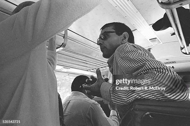 Low-angle view of passengers on a bus on their way home from a visit to Stan Vanderbeek's studio and 'Movie Drome' theatre as part of the New York...