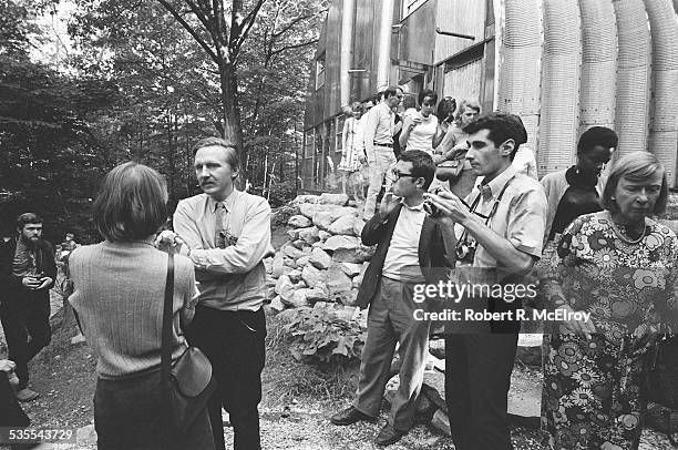 American film director Stan Vanderbeek talks with attendees as he hosts a visit to his studio and 'Movie Drome' theatre as part of the New York Film...