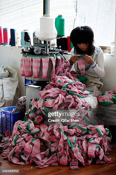 Workers make socks at the Shuangjin Knitting & Textile Co. In Zhuji, Zhuji Province, China on 01 November 2010. The rising cost of labor and raw...