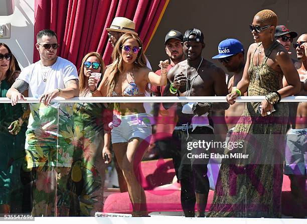 Choreographer/dancer Beau "Casper" Smart looks on as singer/actress Jennifer Lopez dances with guests while hosting the "Carnival Del Sol" pool party...