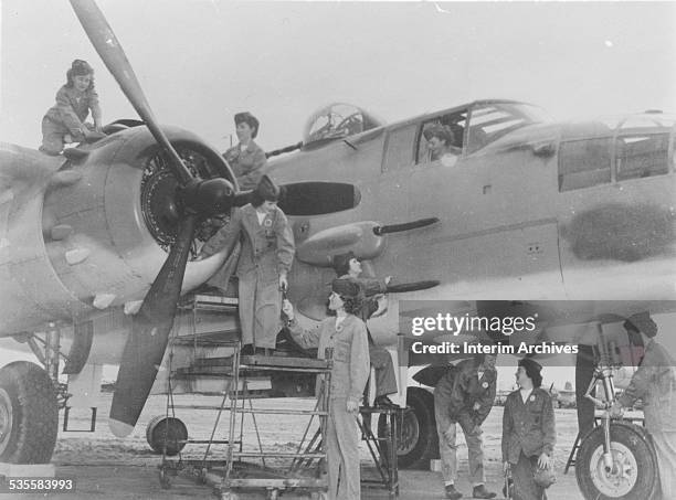 View of women Marines carrying out the repair and reconditioning of fighting airplanes during World War II, 1940s.