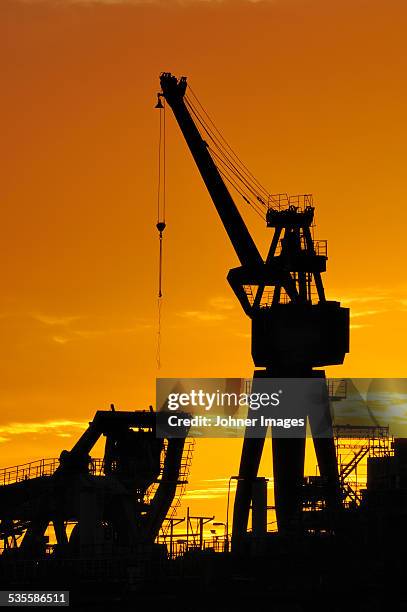 lifting crane at sunset - göteborg silhouette bildbanksfoton och bilder