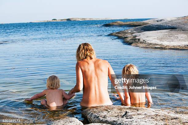 mother with children at sea - families nude stock pictures, royalty-free photos & images