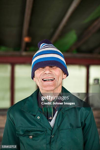 portrait of senior man laughing - shy stockfoto's en -beelden