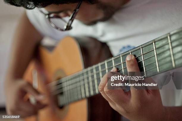 a man plays a flamenco guitar. - puerto rico music stock pictures, royalty-free photos & images