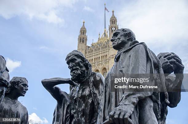 close up burghers of calais (rodin) with westminster abbey behind - burghers of calais stock pictures, royalty-free photos & images