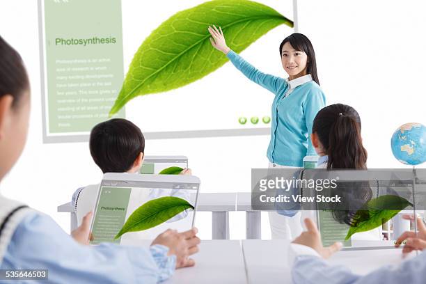elementary students with teacher in classroom - close to stock pictures, royalty-free photos & images