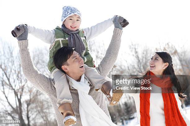 family enjoying in the snow - chinese father and son snow stock pictures, royalty-free photos & images