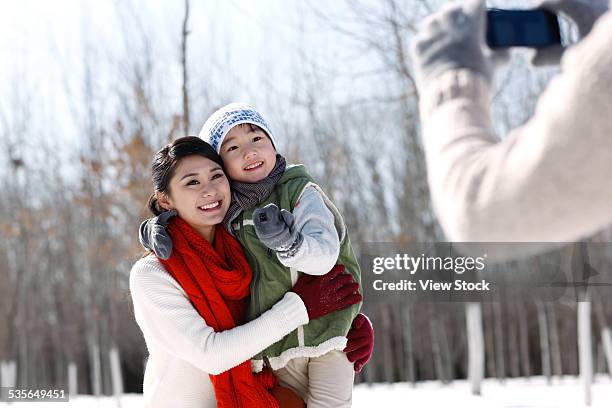 family enjoying in the snow - chinese father and son snow stock pictures, royalty-free photos & images