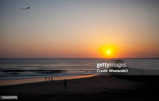 france, aquitaine, capbreton, people relaxing on the beach at sunset - aquitaine stock pictures, royalty-free photos & images