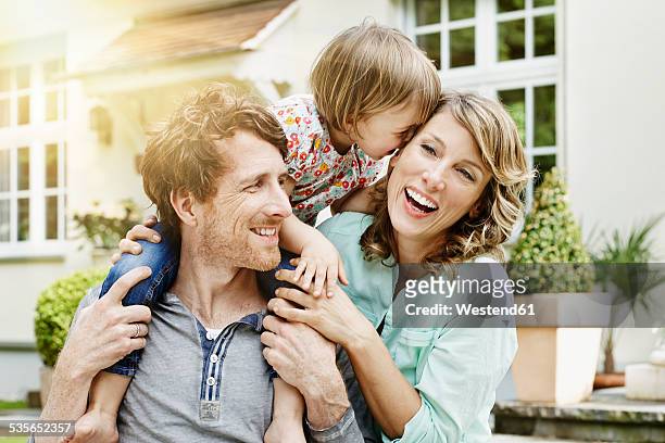 germany, hesse, frankfurt, happy couple with daughter in front of villa - 2 year old blonde girl father stock pictures, royalty-free photos & images