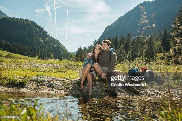 austria, tyrol, tannheimer tal, two happy young hikers relaxing - trolese foto e immagini stock