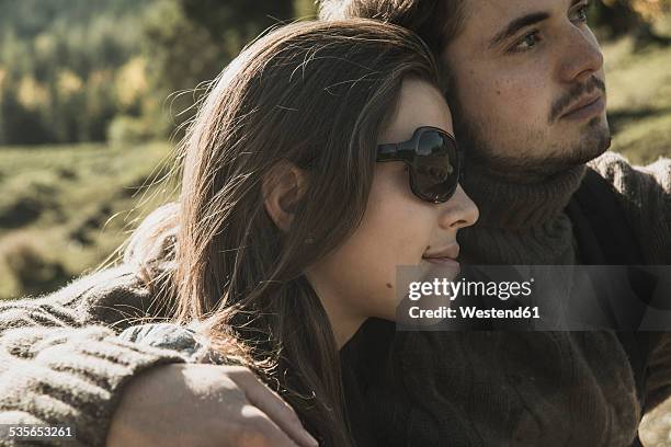 austria, tyrol, tannheimer tal, young couple watching landscape - tirol deelstaat stockfoto's en -beelden