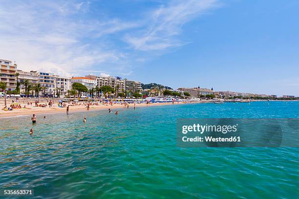 france, cote d'azur, cannes, tourists on beach - cannes beach stock pictures, royalty-free photos & images